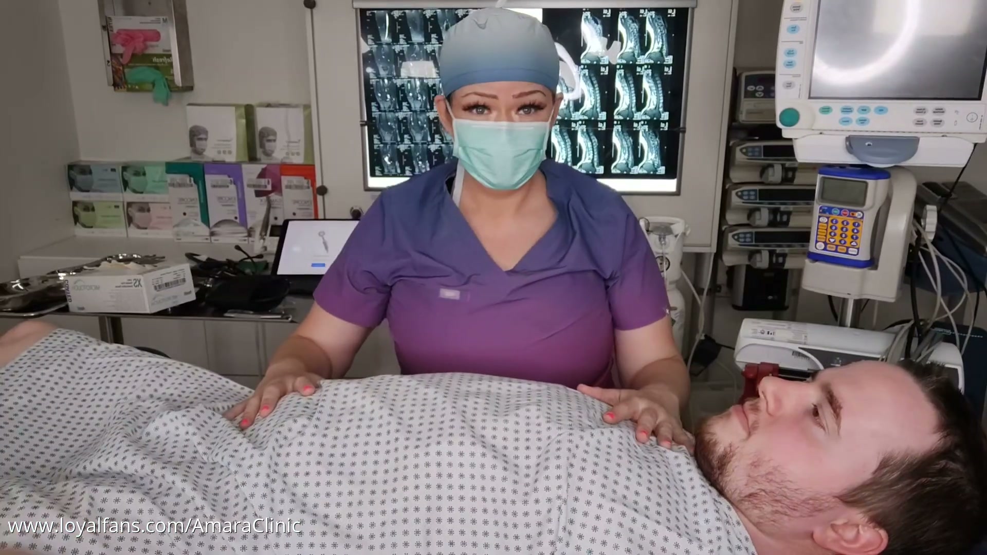 Mistress Katharina Amara pressing a Littmann stethoscope to a cardiac patient chest in the free auscultation fetish heart examination video from Amara Fetish Clinic Belgium
