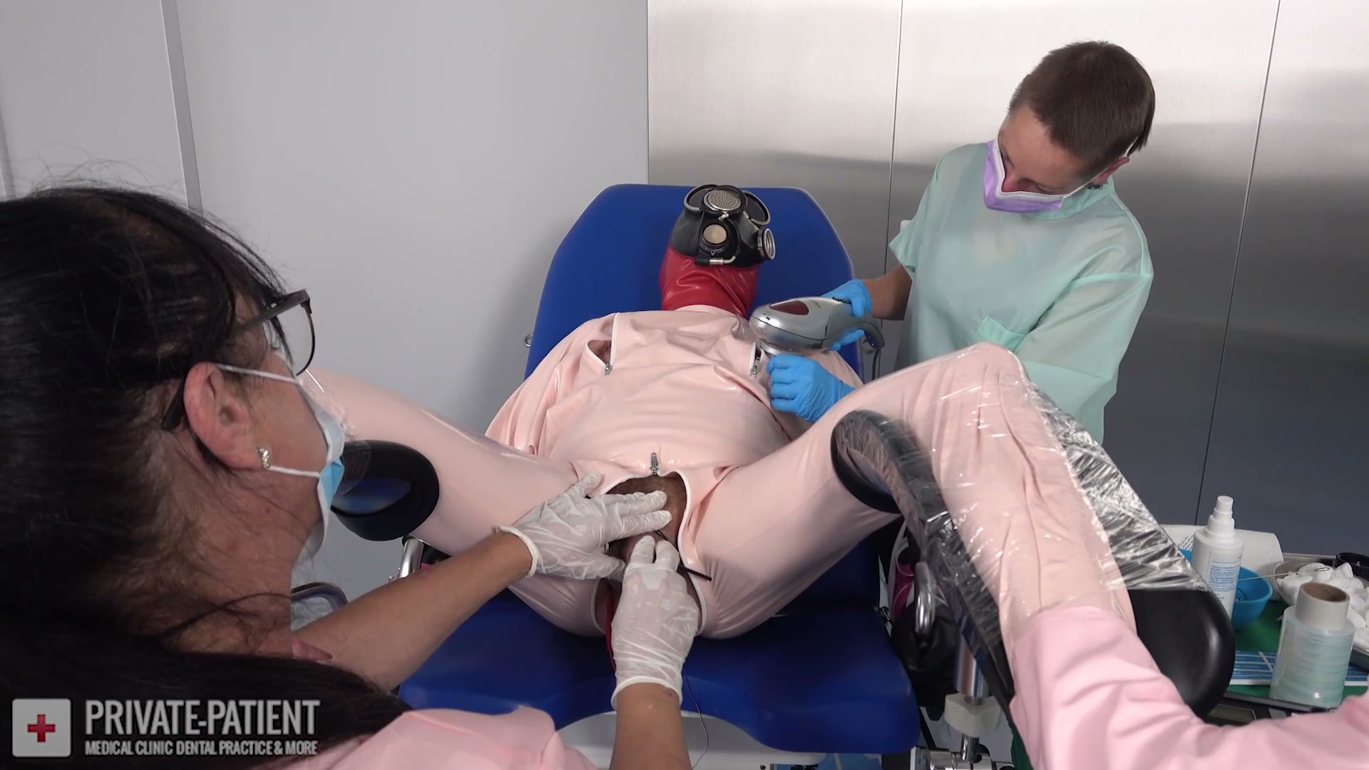 Dr. Fuchs and Dr. Ira examining their French private patient in the free Visitor From France 07 medical BDSM video from Amara Fetish Clinic Belgium