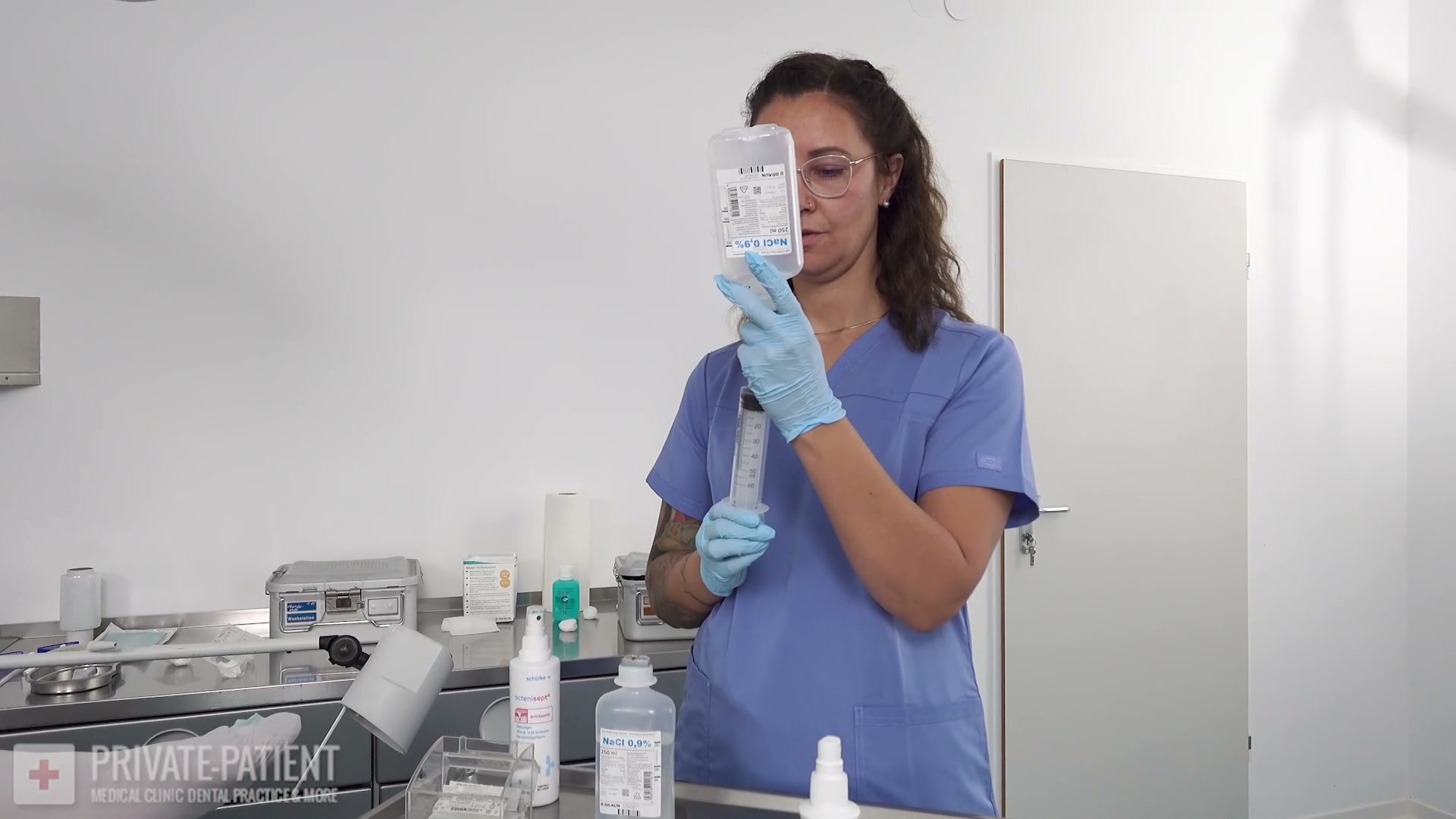 Dr. Eve preparing medication and teaching Dr. Lana van Orten in the free Welcome Dr. Lana part five medical BDSM video from Amara Fetish Clinic Belgium